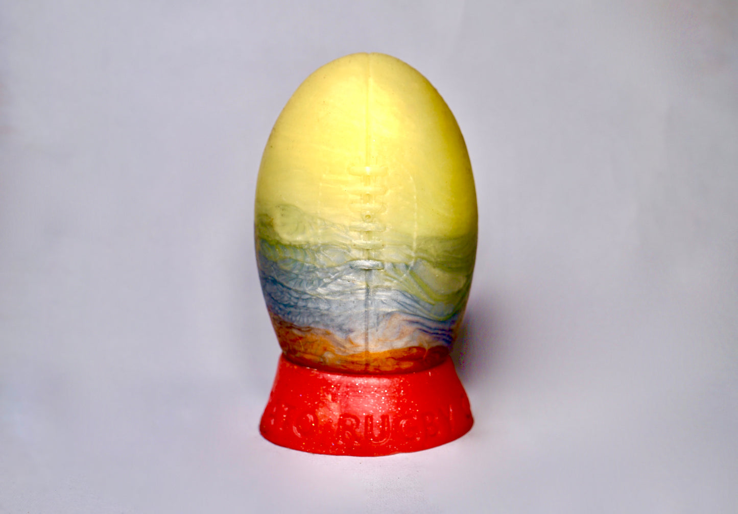The Heavy Trundle Rugby Ball - Size Medium, Gold, Silver and Bronze, with a red base.